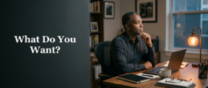 Established business owner pausing at his home office desk at the end of the day, facing the question of what he actually wants from the business he built.